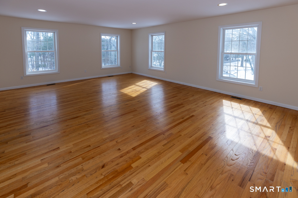 85 McVeagh Road Westbrook, CT 06498 - Photo 19 of 39 a view of an empty room with wooden floor and window