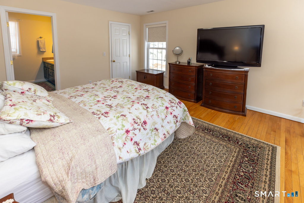 85 McVeagh Road Westbrook, CT 06498 - Photo 21 of 39 a bedroom with a bed and a flat screen tv