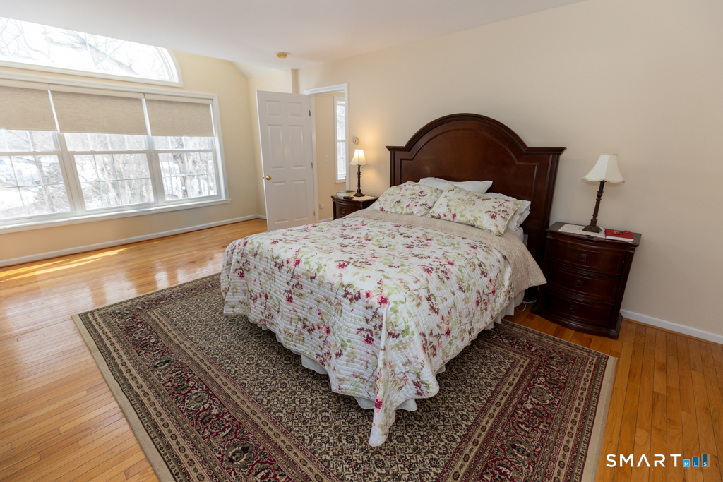 85 McVeagh Road Westbrook, CT 06498 - Photo 23 of 39 a bedroom with a bed and wooden floor