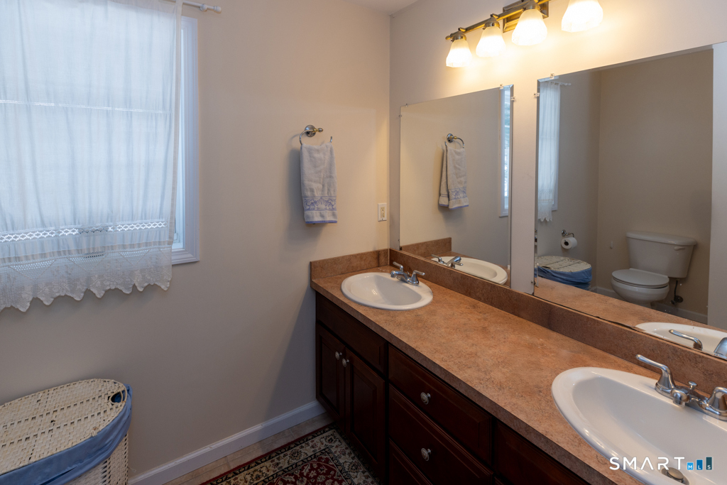 85 McVeagh Road Westbrook, CT 06498 - Photo 24 of 39 a bathroom with a granite countertop sink and a mirror