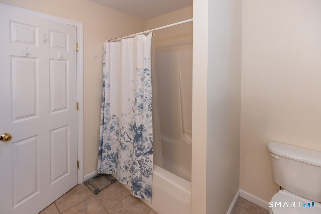 85 McVeagh Road Westbrook, CT 06498 - Photo 25 of 39 a bathroom with a toilet and shower curtain