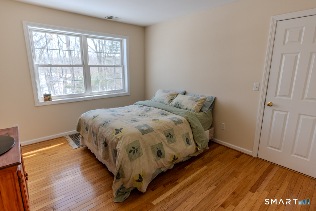 85 McVeagh Road Westbrook, CT 06498 - Photo 26 of 39 a bed sitting in a bedroom next to a window