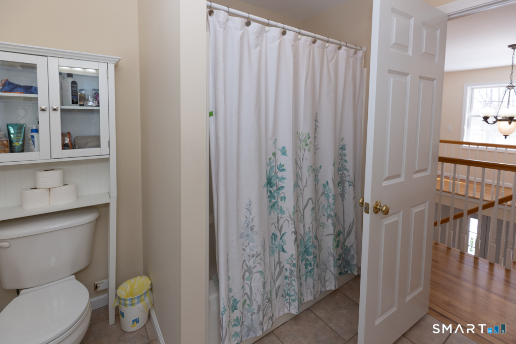 85 McVeagh Road Westbrook, CT 06498 - Photo 28 of 39 a bathroom with a toilet a sink and shower curtain