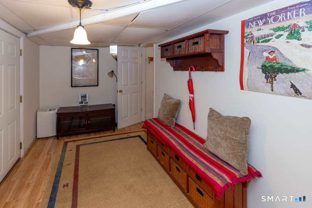 85 McVeagh Road Westbrook, CT 06498 - Photo 32 of 39 a living room with furniture and a flat screen tv