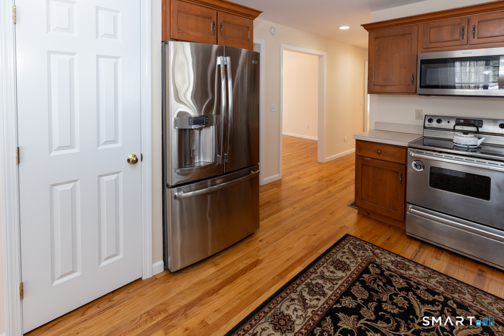 85 McVeagh Road Westbrook, CT 06498 - Photo 7 of 39 a kitchen with stainless steel appliances a refrigerator and a stove top oven