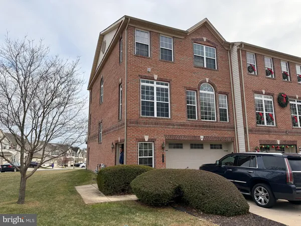 a view of a car parked in front of a brick house