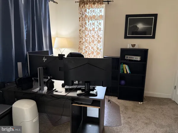 a living room with furniture a flat screen tv and a window