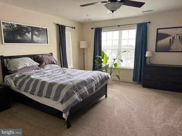a large bed sitting in a bedroom next to a window