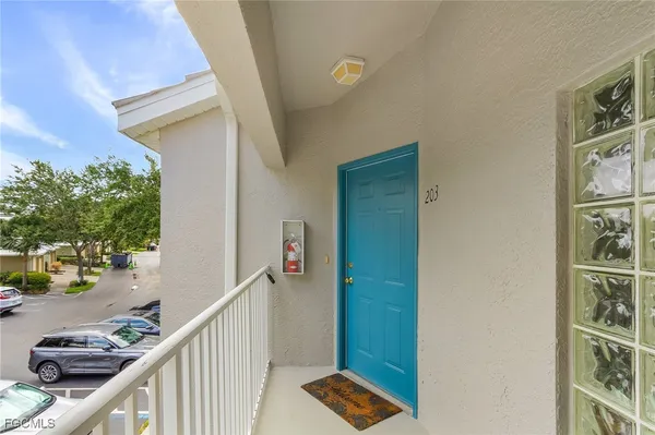 a view of a balcony and car parked