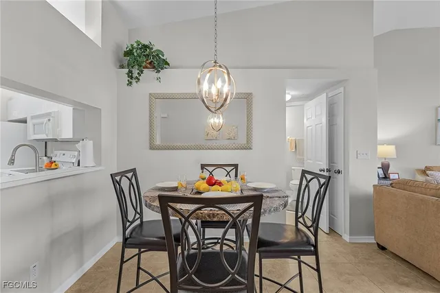 a view of a dining room with furniture and chandelier