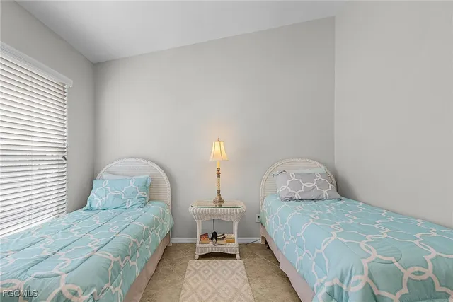 a bedroom with two beds and a window