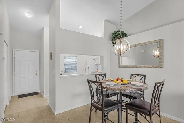 a view of a dining room with furniture a chandelier and wooden floor