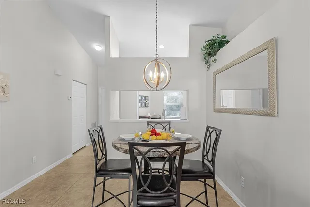 a view of a dining room with furniture and chandelier