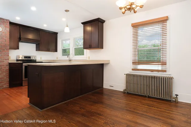 a view of a house with backyard and a garden