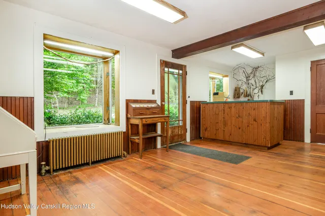 a view of a kitchen with kitchen island a large window in it