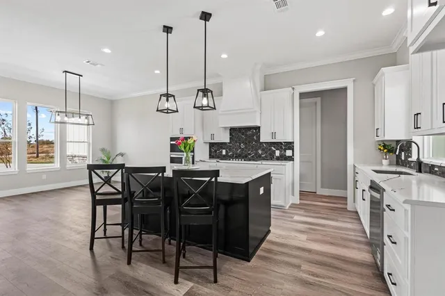 a kitchen with a sink and cabinets