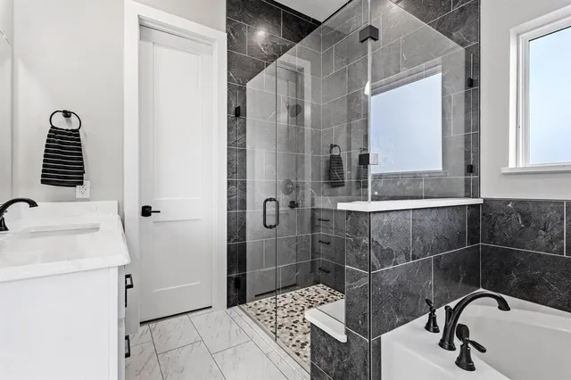 a bathroom with a sink a stove and a mirror