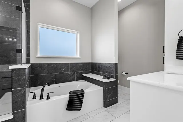 a bathroom with a double vanity sink mirror and shower