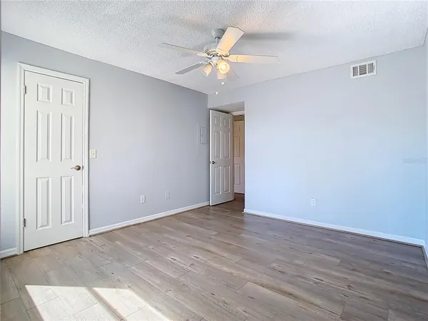 a view of an empty room with wooden floor