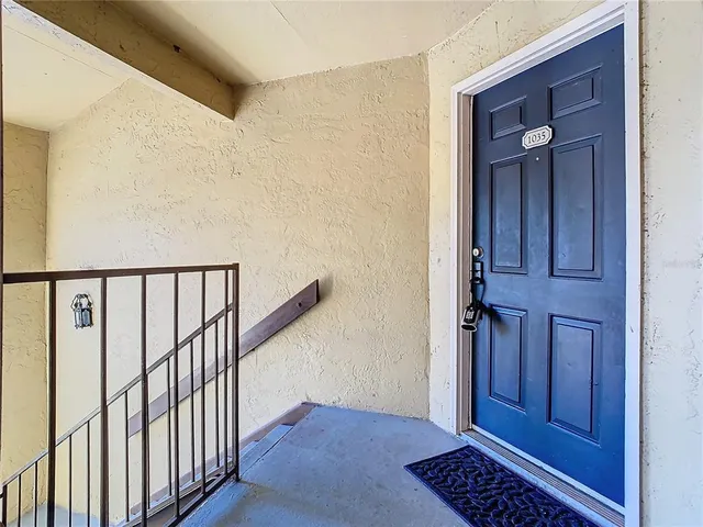 a view of a hallway with wooden floor and entryway