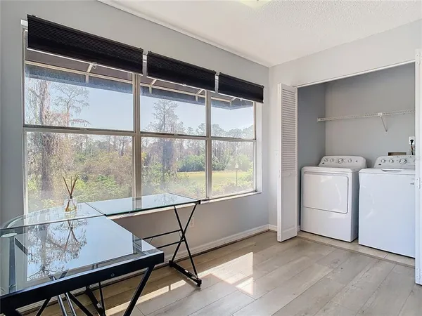 a view of a workspace with furniture and a window