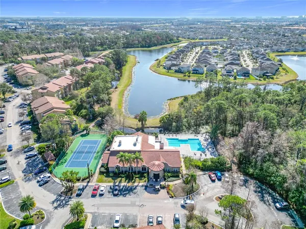 an aerial view of residential houses with outdoor space and parking