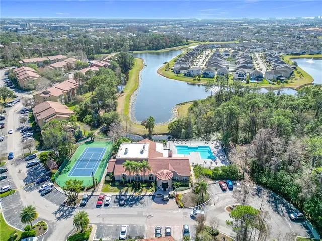 an aerial view of residential houses with outdoor space and parking