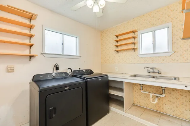 a utility room with sink dryer and washer
