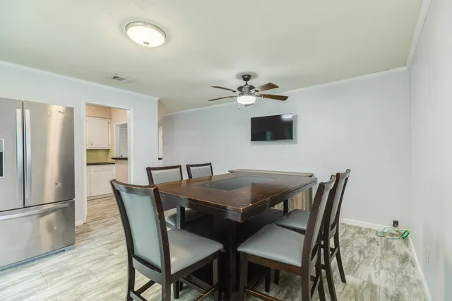 a view of a dining room with furniture and wooden floor
