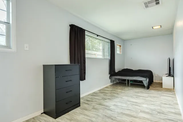 a bedroom with a bed and a window