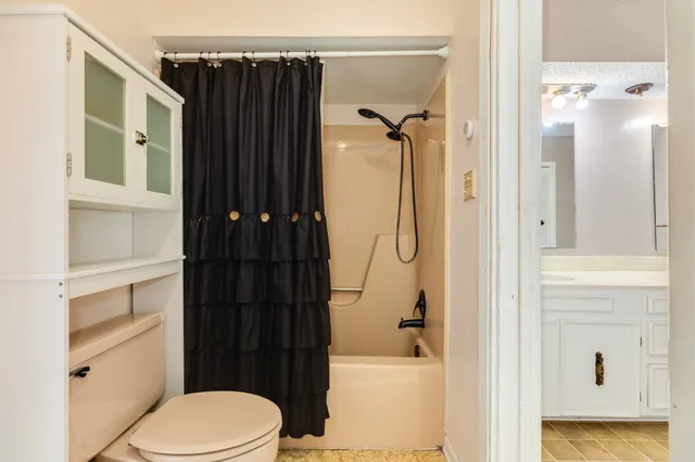 a bathroom with a shower toilet and sink