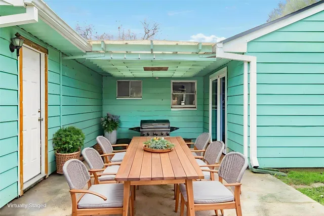 a view of a patio with table and chairs potted plants with wooden floor