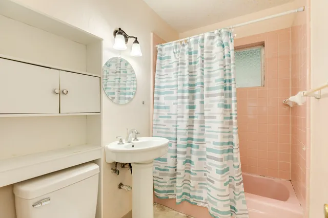 a bathroom with a sink a mirror and shower