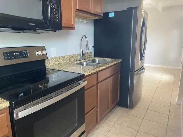 a kitchen with a stove microwave and sink