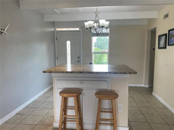 a view of a workspace with furniture and window