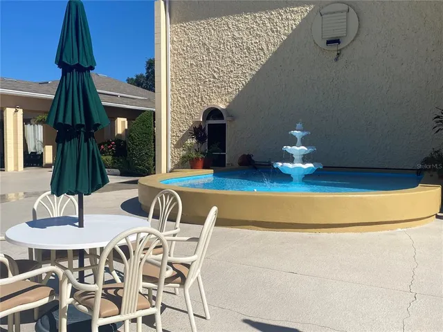 a view of a chairs and table in a backyard