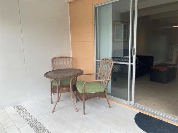 a view of a balcony with a table and chairs