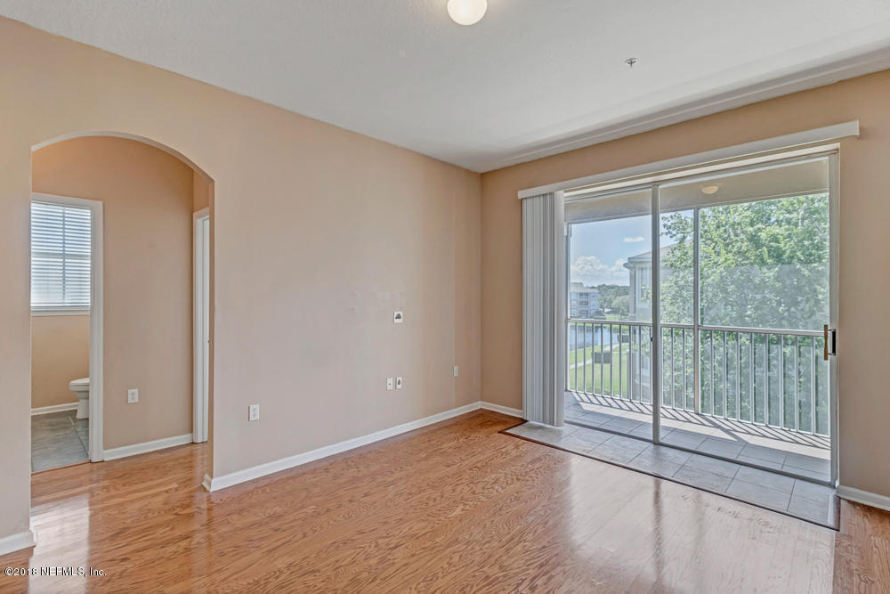 7990 Baymeadows Road East, Unit 211 Jacksonville, FL 32256 - Photo 10 of 21 a view of empty room with wooden floor and fan
