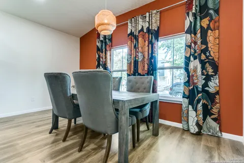 a dining room with furniture and wooden floor