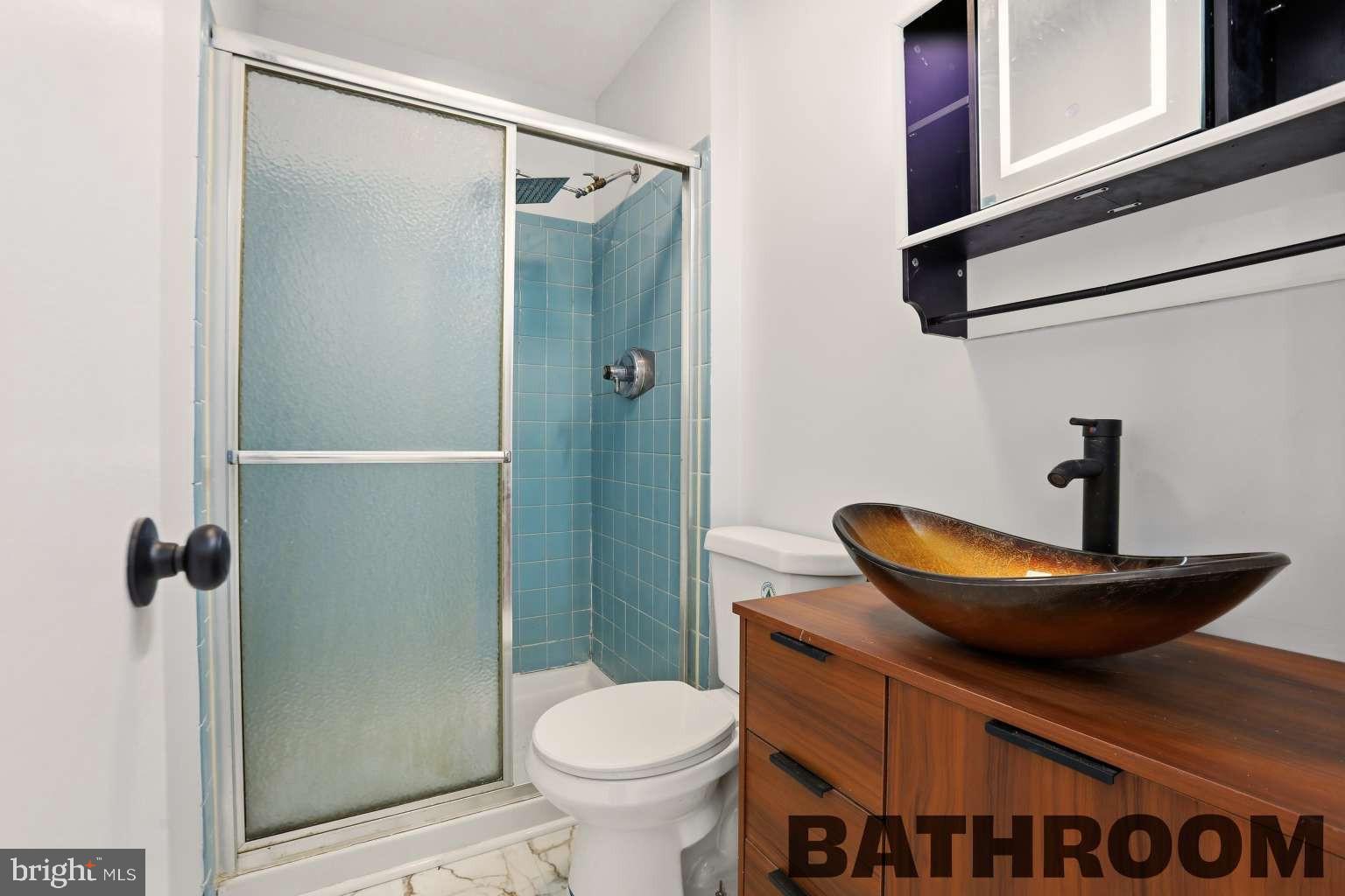 960 Jamestown Road Hightstown, NJ 08520 - Photo 13 of 18 a bathroom with a granite countertop toilet and a shower