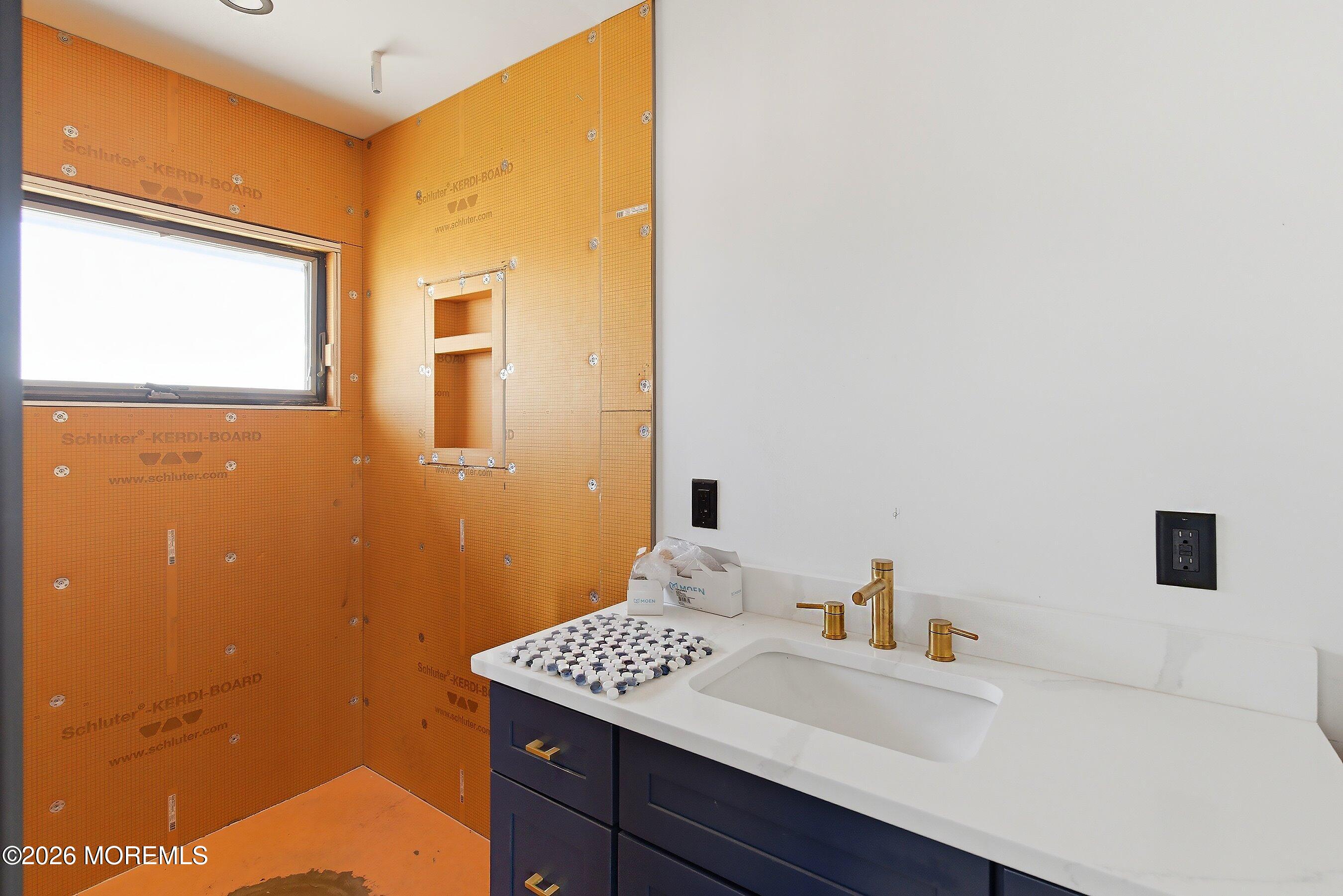 48 Parker Road Tuckerton, NJ 08087 - Photo 12 of 35 a bathroom with a sink a mirror and a shower
