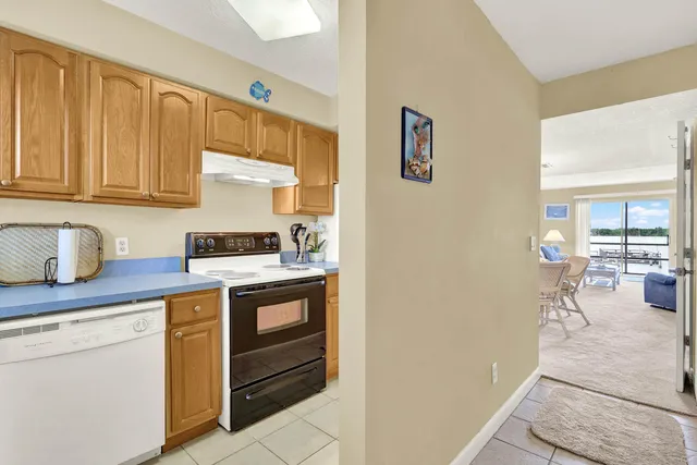 a kitchen with a stove cabinets and a refrigerator