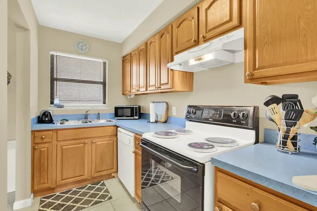 a kitchen with a sink cabinets and appliances
