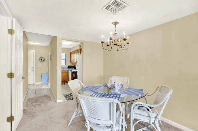 a view of a dining room with furniture and chandelier