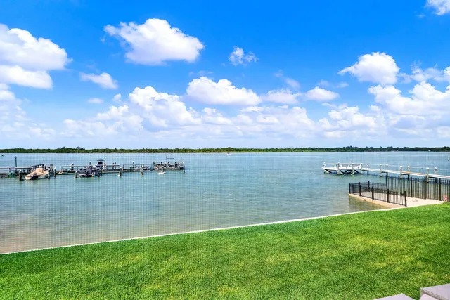a view of a lake with houses in the back