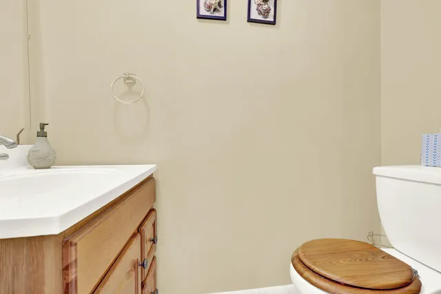 a white toilet sitting next to a bathroom sink