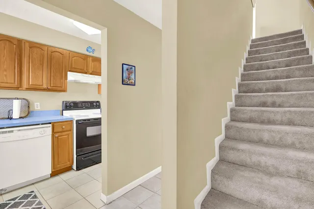 a kitchen with granite countertop white cabinets and white appliances