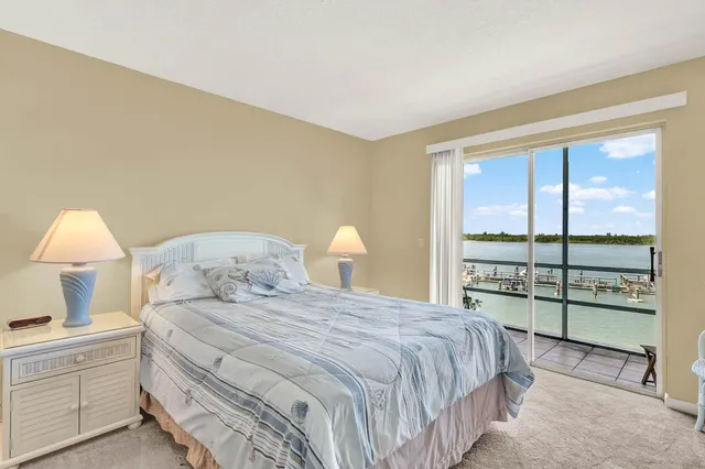 a bedroom with a large bed and a lamp next to a window