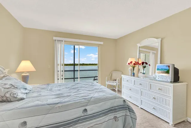 a bedroom with a bed and a dresser in it