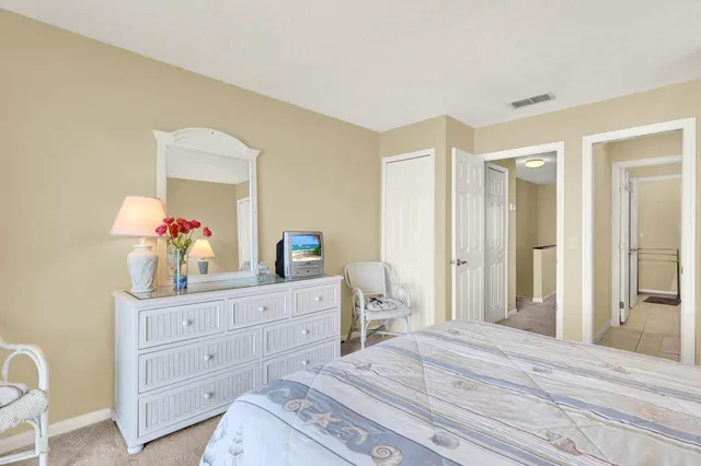 a bedroom with a bed and a dresser